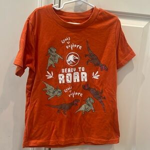 TWO Jurassic world tees - one size 7(orange) and one size 6(gray)